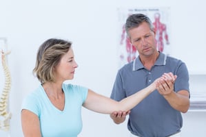 Doctor examining a woman's wrist