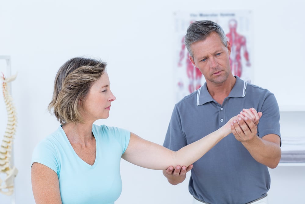 Doctor examining a woman's wrist