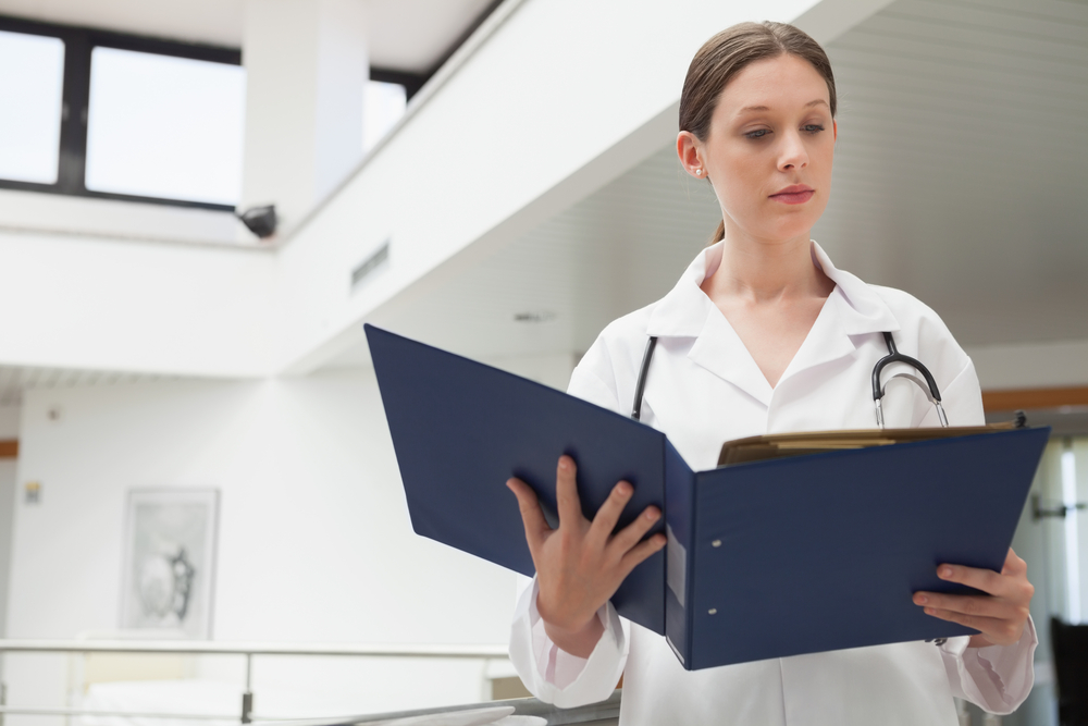 Female provider reviewing chart documents